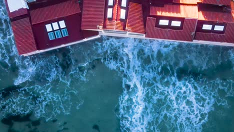 Aerial-view-of-ocean-waves-crashing-into-Oceanfront-homes
