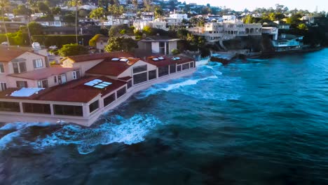 drone-view-of-ocean-waves-hitting-oceanfront-restaurants