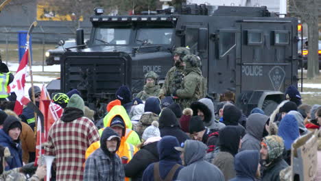 Military-armoured-vehicle,-police-and-forces-patrol-freedom-convoy-public-protest,-Windsor-Ontario,-Canada