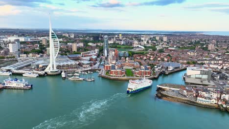 Panning-Wide-Drone-Shot-of-the-Spinnaker-Tower-at-Sunset-with-a-Ferry-Arriving-in-Portsmouth-4K