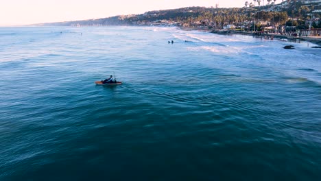 Aerial-footage-of-a-kayaker-launching-through-the-surf