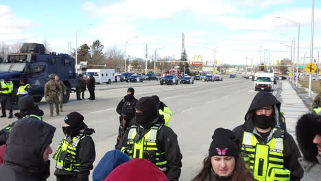 A-panning-shot-of-police-stopping-the-freedom-protest,-with-a-lot-of-officers-present