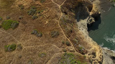Luftaufnahme-Von-Oben-Nach-Unten-Auf-Wanderwege,-Die-Sich-Entlang-Der-Sandigen-Klippen-Kaliforniens-Schlängeln