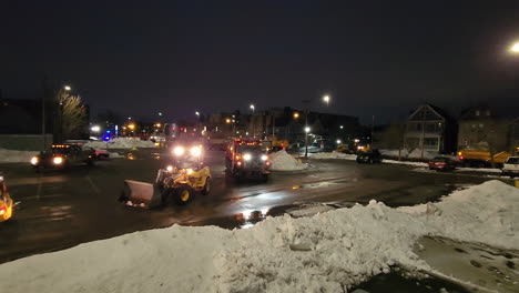Pan-shot-revealing-the-bulldozers,-trucks-and-heavy-equipment-being-used-in-the-emergency-clean-up-operation-after-a-blizzard-storm-in-Buffalo-New-York
