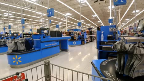 POV---Pushing-a-grocery-cart-past-registers-and-empty-checkout-stations-of-a-large-mega-mart-large-American-grocery-store