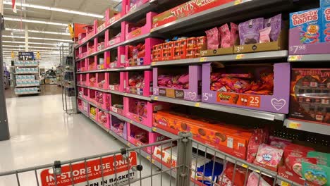 POV---Pushing-a-grocery-cart-past-the-displays-of-Valentines-candy-in-an-American-grocery-store