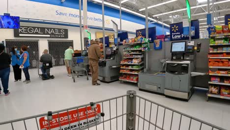 POV---Pushing-a-grocery-cart-through-the-self-checkout-area-in-a-large-American-grocery-store