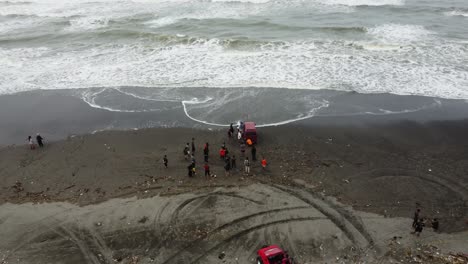 Yogyakarta,-Indonesia---Feb-5,-2023-:-a-car-stuck-in-the-sand-by-the-beach