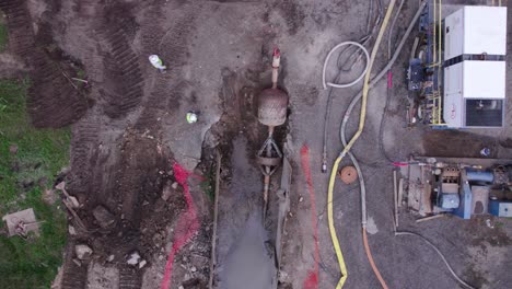 Rising-overhead-aerial-of-water-main-pipe-construction-site-in-USA