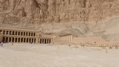 Establishing-shot-of-Temple-of-Hatshepsut-carved-on-Sandstone-mountain-wall,-Luxor---Egypt