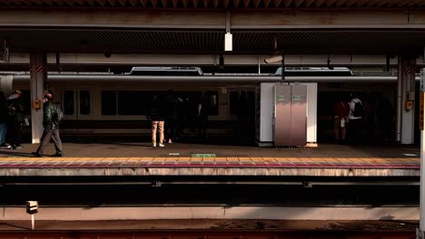 People-Standing-and-Waiting-for-Train-That-Arrives-at-Yamagata-Station,-Japan