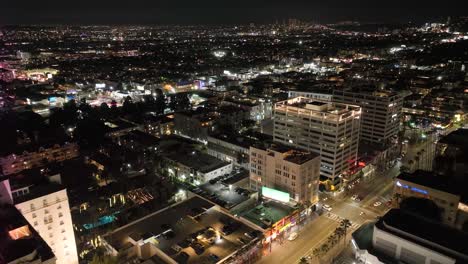 Flying-over-Roosevelt-Hotel-in-Hollywood-California-at-nighttime---establishing-aerial-shot