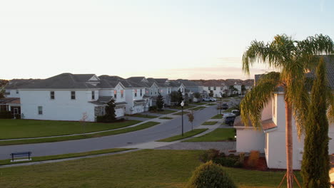 Aerial-view-over-quiet-streets-with-wealhy-family-homes,-sunset-in-Florida,-USA---reverse,-drone-shot