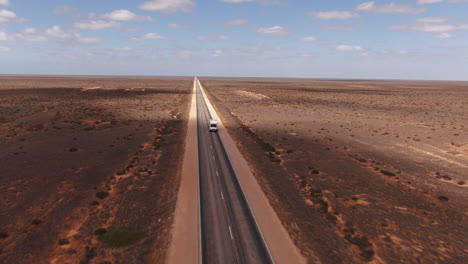 Camper-Van-Driving-Down-Empty-Rural-Road,-Aerial-Wide-Angle,-Nullarbor-Australia
