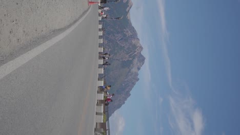 Turistas-Al-Borde-De-La-Carretera-Con-Vistas-A-Las-Impresionantes-Montañas-Y-Al-Cielo-Azul-En-Bariloche,-Patagonia,-Argentina