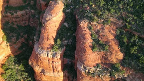 Low-angle-to-high-angle-shot-aerial-view-of-red-rock-mountains-flying-in-Sedona