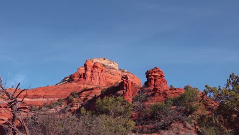 Boynton-Canyon-Vortex-pan-down-against-blue-sky-with-red-rock-canyons-and-spires