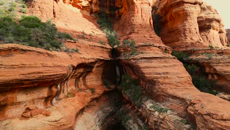 Drone-pulling-out-of-red-rock-features-in-Sedona-Arizona-reveals-mountainside