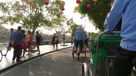 A-point-of-view-shot-of-a-tourist-passenger-riding-on-a-local-cyclo-transportation-to-roam-around-the-City-of-Hoi-An-in-Vietnam