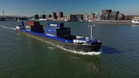 Aerial-view-following-containership-"Fenny-ll"-in-the-canal-of-Dordt,-The-Netherlands