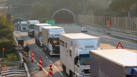 Tractor-trailer-trucks-stuck-in-heavy-traffic,-driving-slowly,-static,-day