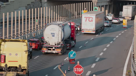 Rear-view-of-trucks-trailers-carrying-goods-on-heavy-traffic-highway-road