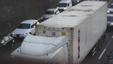 High-angle-view-of-cars-passing-down-overpass-bridge,-moving-slow-due-to-traffic