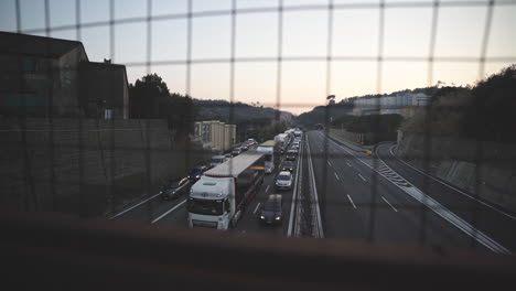 Heavy-traffic-jam-establisher-seen-from-overpass-bridge-at-dusk,-slidign