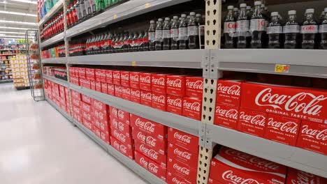 Slowly-passing-displays-of-cola-soda-in-an-American-mega-grocery-store