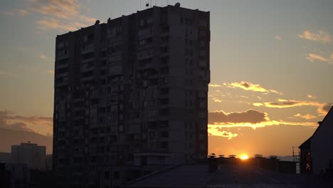 Atemberaubender-Sonnenuntergang-Hinter-Den-Lichtern-Eines-Alten-Europäischen-Apartmentgebäudes,-Atemberaubende-Wolken