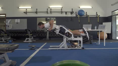 Slow-motion-shot-of-a-rugby-player-doing-a-one-legged-exercise-in-a-rugby-gym-in-France
