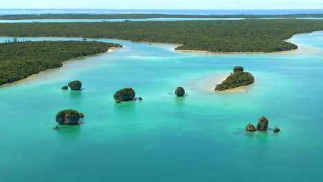 Flyover-above-Upi-Bay's-famous-floating-rocks,-Isle-of-Pines,-New-Caledonia