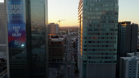 Traffic-at-the-Van-Buren-street-in-downtown-Phoenix,-USA---descending-drone-shot