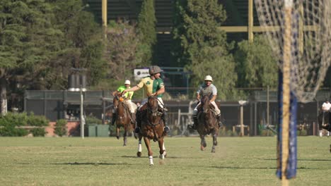 Group-of-man-playing-popular-Pato,-the-national-sport-of-Argentina,-riding-on-horseback,-throwing-horseball-ball-with-handles-around,-racing-to-the-gate-at-the-end-of-the-field,-slow-motion-shot