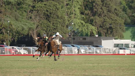 Outdoor-sport,-traditional-pato-horseball-game-playing-in-field-with-opponent-chasing,-whipping-the-horse-to-speed-up-and-riding-closer-to-the-player-with-the-ball-on-his-right-hand,-Campo-Argentino