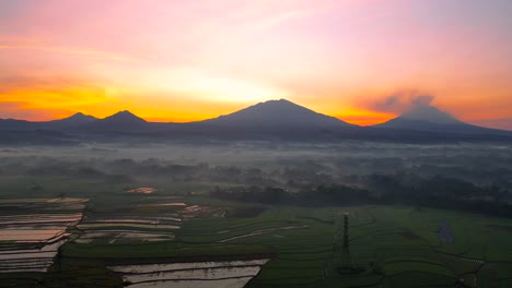 Aerial-view-of-rural-landscape-with-mountain-range-and-sunrise-sky
