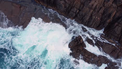 Ocean-Waves-Hitting-Rocky-Cliffs-In-Arteixo,-Spain---aerial-orbit