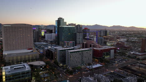 Aerial-view-away-from-the-Arizona-State-University-Downtown-Phoenix-Campus,-sunset-in-USA---pull-back,-drone-shot