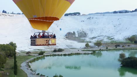 Aerial-view-hot-air-balloon-flight-over-Natural-travertine-pools-and-terraces-in-Pamukkale-early-in-the-morning-sunrise