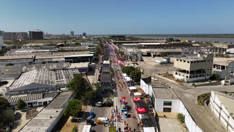 Drone-shot-over-the-Parade-at-the-Carnival-of-Barranquilla,-in-sunny-Colombia