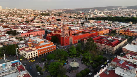 Aerial-view-over-the-Zenea-Garden,-towards-the-Templo-de-San-Francisco-church,-sunny-evening-in-Queretaro-city,-Mexico