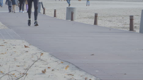 A-man-runs-along-the-beachfront-boardwalk-among-passersby