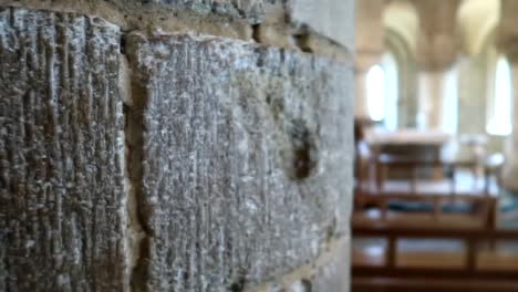 Revealing-shot-of-an-alter-and-pews-in-a-stone-building-within-the-Tower-of-London