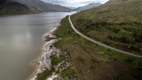 Lonely-Mountain-Road-Runs-Along-Lake,-Loch-Claunie-A87-Road-Isle-Of-Skye