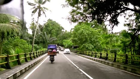 Traveler-POV-riding-through-roads-of-Ubud,-Bali-Indonesia-on-motorbike