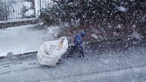 Istanbul,-Turkey---February-14,-2021:-A-young-man-who-is-a-paper-collector-trying-to-do-his-job-in-a-blizzard-in-Istanbul-in-super-slow-motion