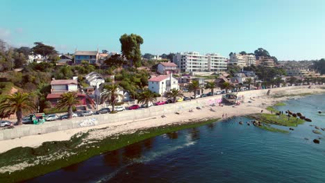 Slow-motion-aerial-shot-toward-luxury-seafront-apartments-looking-onto-Pejerrey-beach