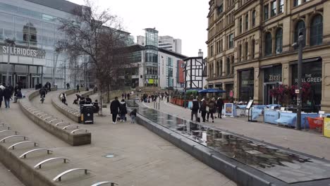 Exchange-Square,-Manchester,-showing-old-and-new-building-facades-and-people-shopping,-Manchester,-England,-UK