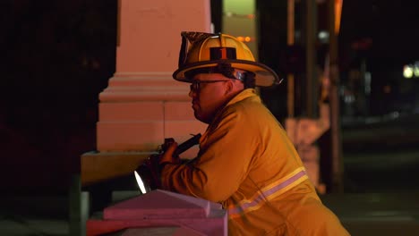 firefighter-searching-for-victim-with-flashlight