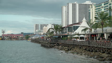People-Enjoy-Seascape-View-from-Waterfront-Esplanade-in-Kota-Kinabalu,-Sabah,-Malaysia
